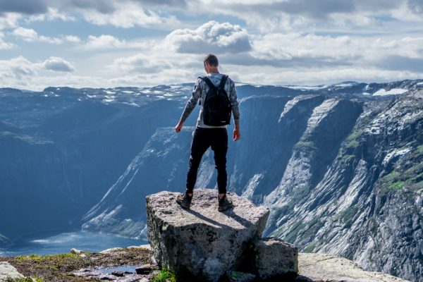 Man standing on edge of cliff